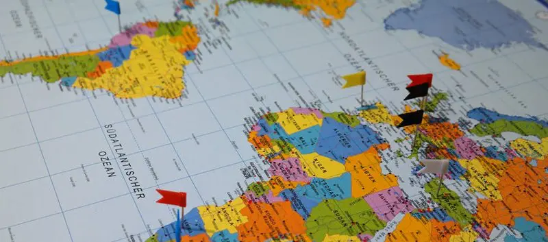 International map with flag pins.