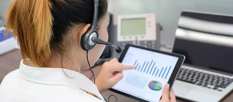 Lady with headset using a tablet.