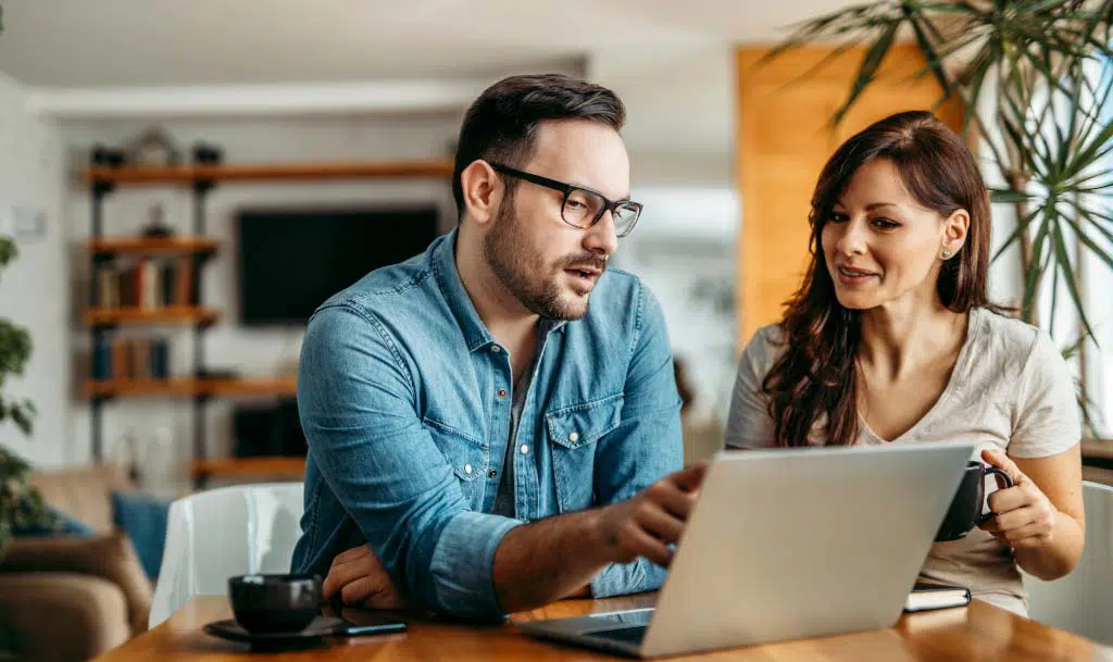 Lady and man looking at a laptop.