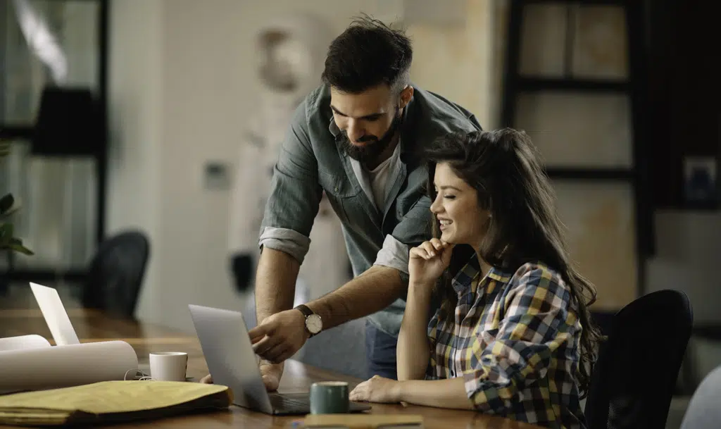 Two marketers reviewing web analytics.