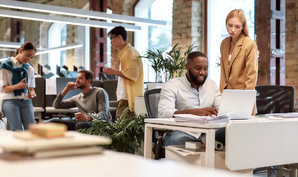 Five people working in a technology business.