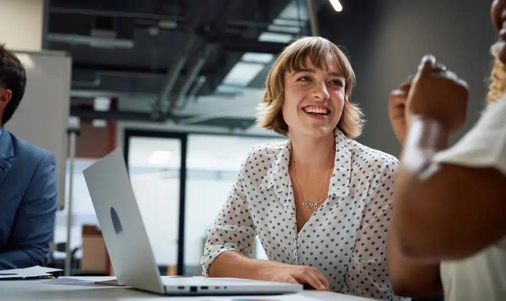 Lady laughing with a colleague.