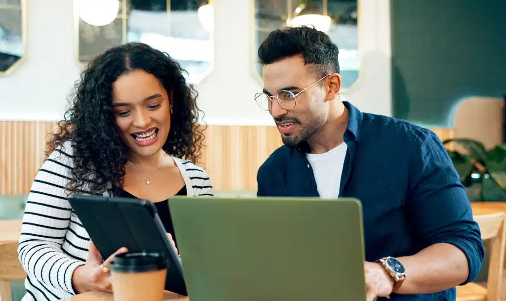 Lady and man sitting ar a desk looking at call tracking metrics.