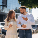 Man and woman in dealership drinking coffee.