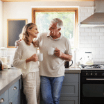 Man and woman in home drinking coffee.