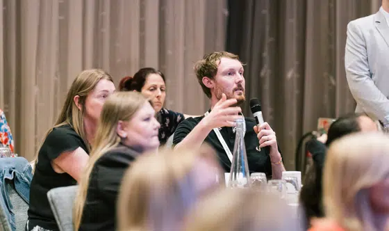 Client asking Mediahawk a question at Xchange Analytics 2025.